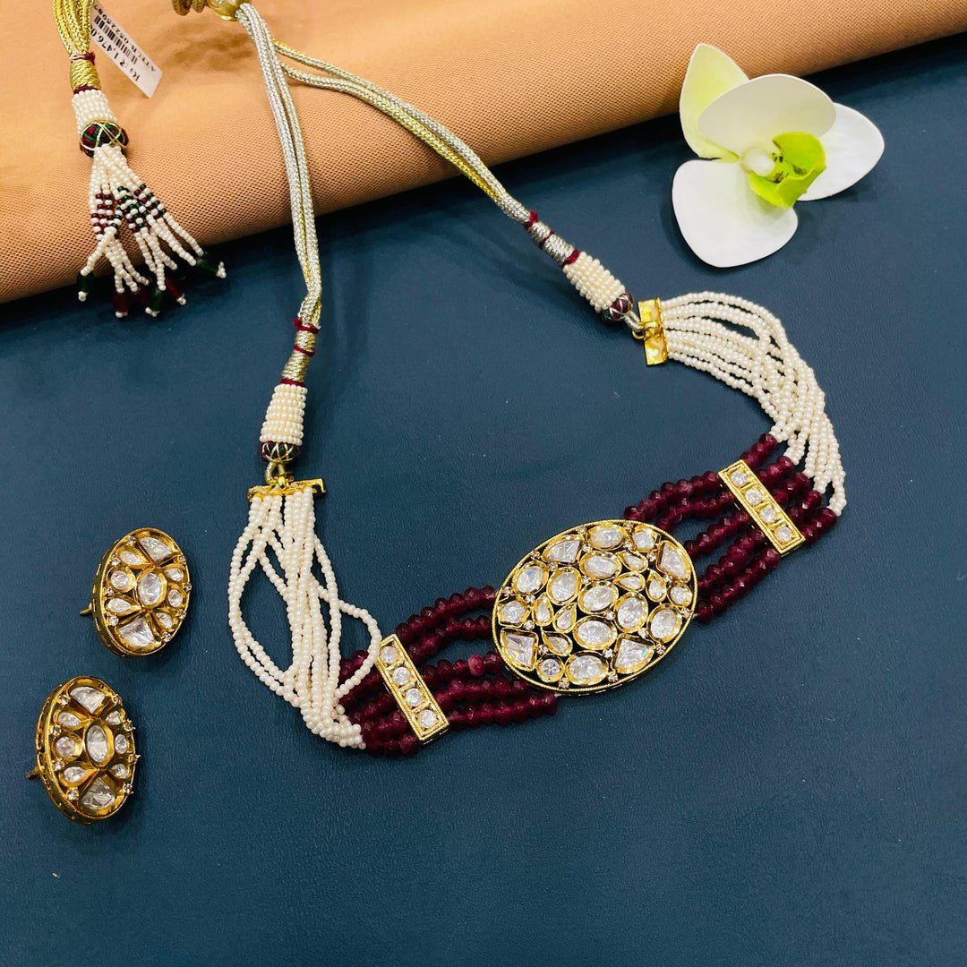 Designer Indian choker set in gold metal, featuring antique details perfect for weddings or cultural events.