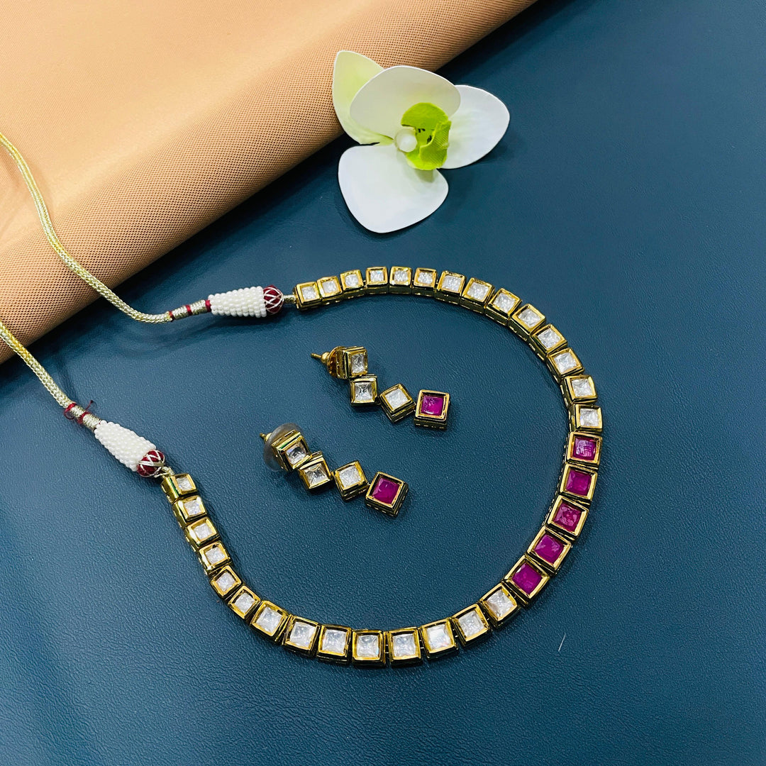 Traditional gold-tone Kundan set, designed with intricate Indian patterns.