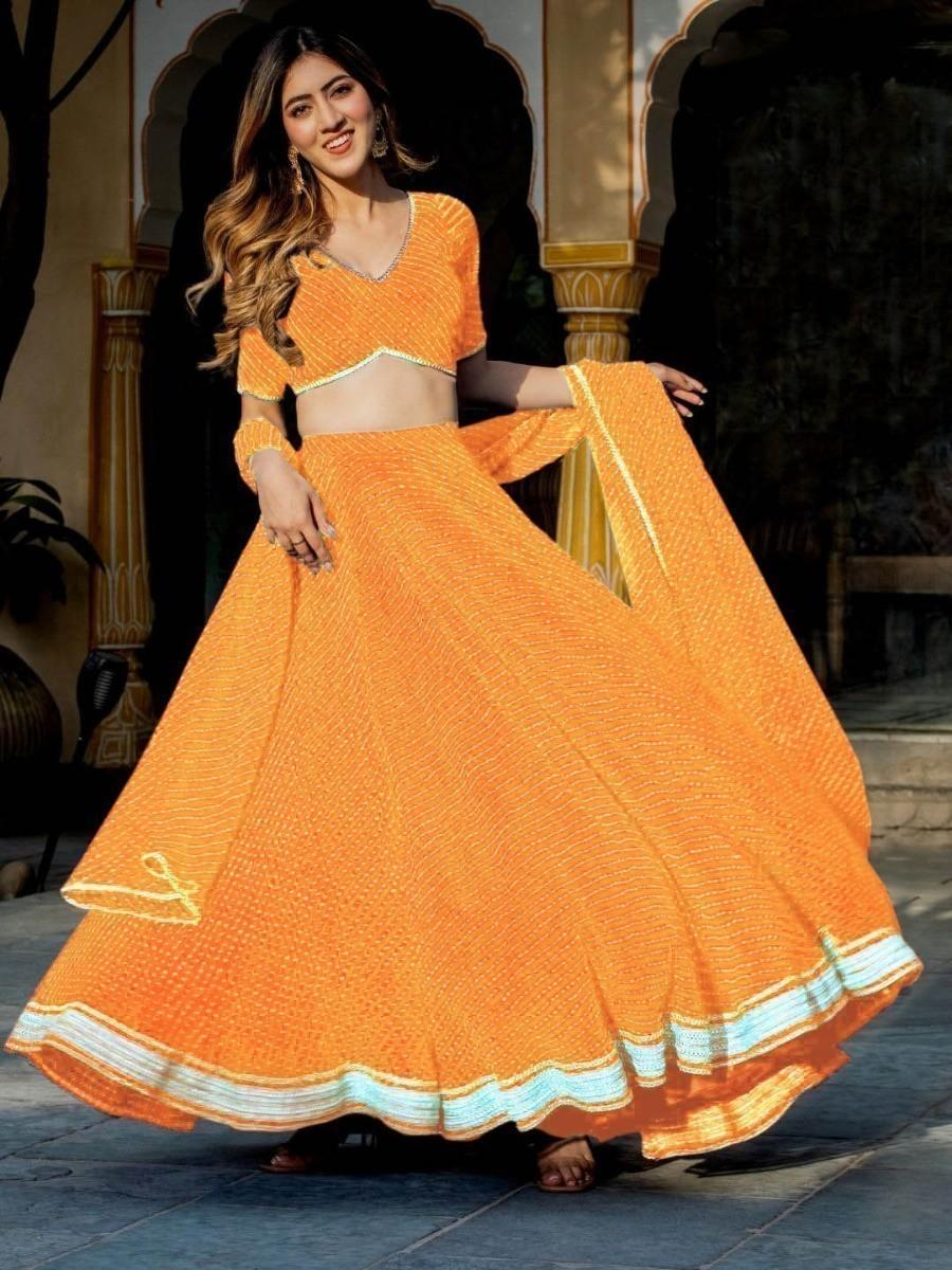 Elegant party wear lehenga in traditional orange color.