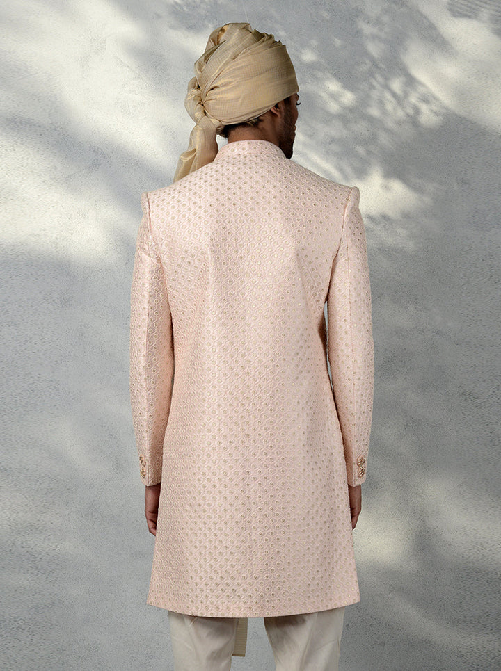 Traditional Pink Indo Western dress for men with embroidered buttons, brooch, and silk blend fabric.