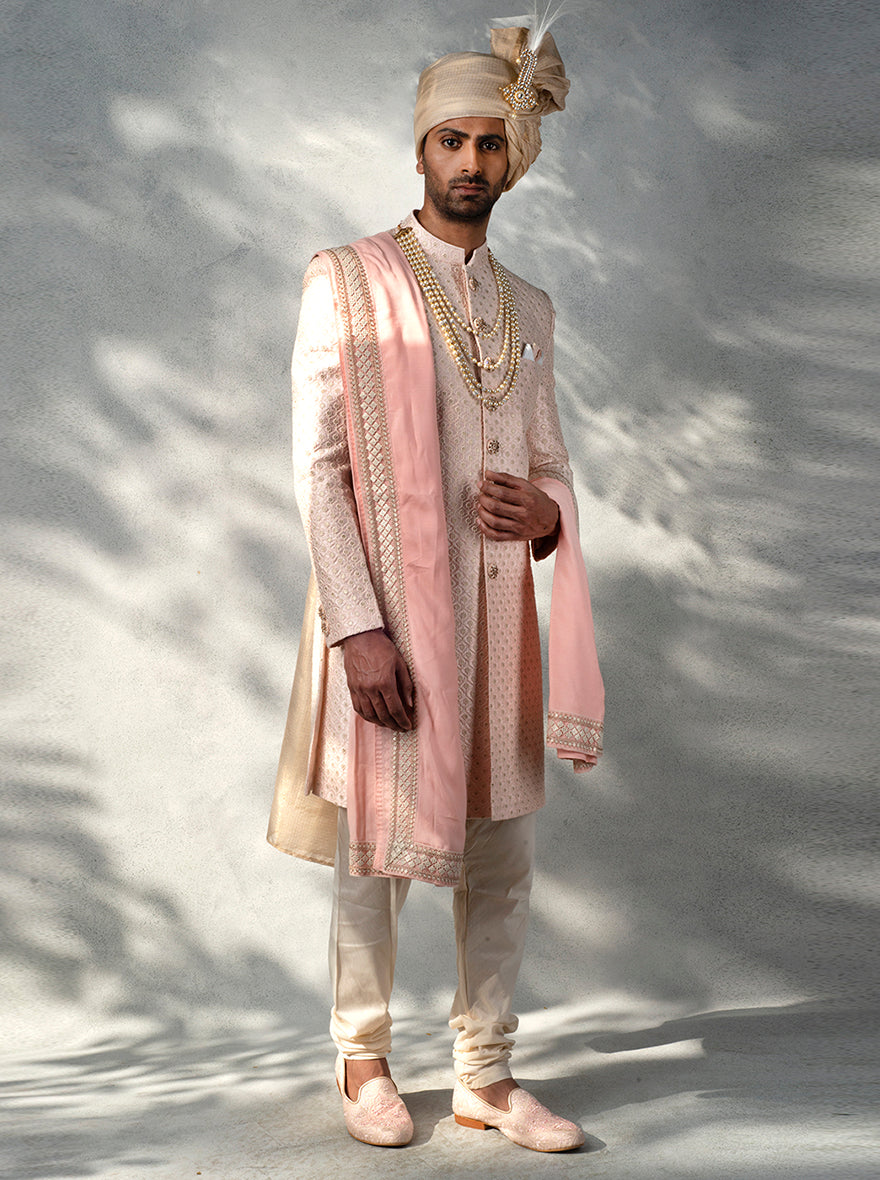 Pink Indo Western outfit for men with full sleeves, sequins butti jaal, and embroidered design for weddings.
