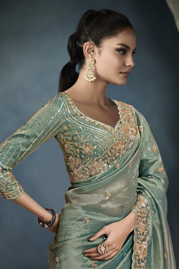 Luxurious Tissue Saree in Green with Handwork Detailing