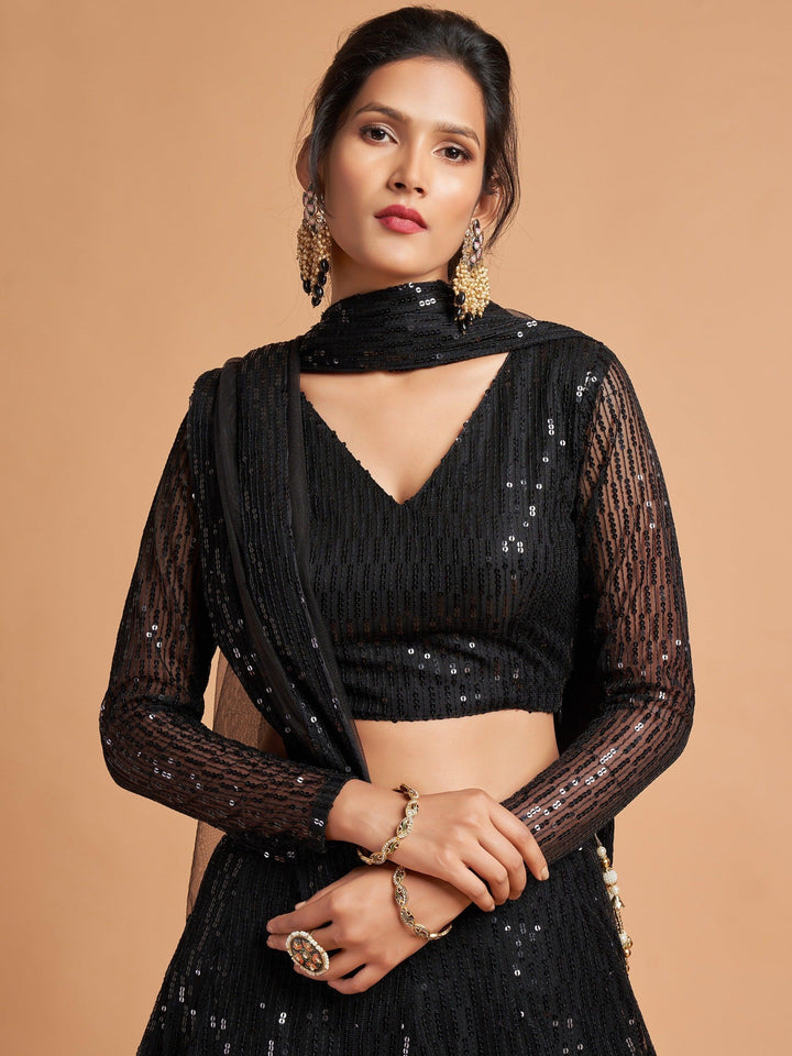 Black party wear lehenga with soft net blouse and embroidered dupatta for special occasions.