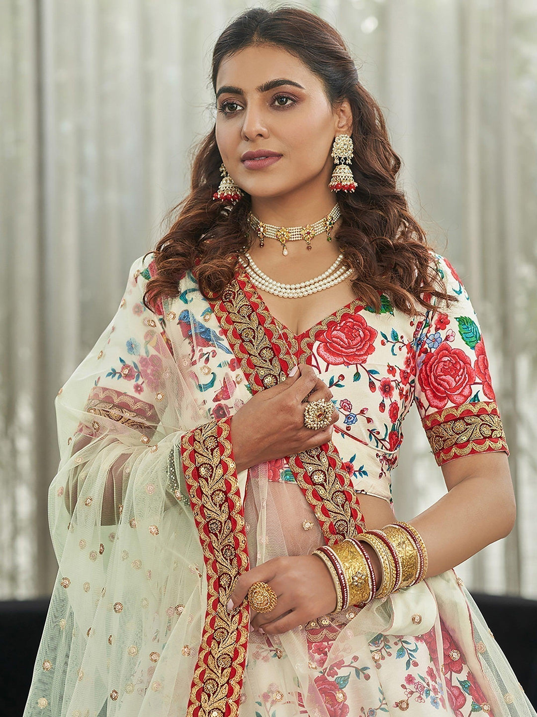 Traditional off-white lehenga with stonework, sequins, and lace details.