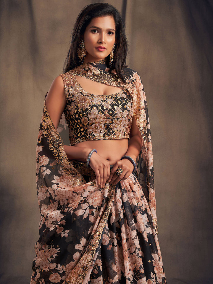 Semi-stitched black crop top lehenga with intricate floral designs