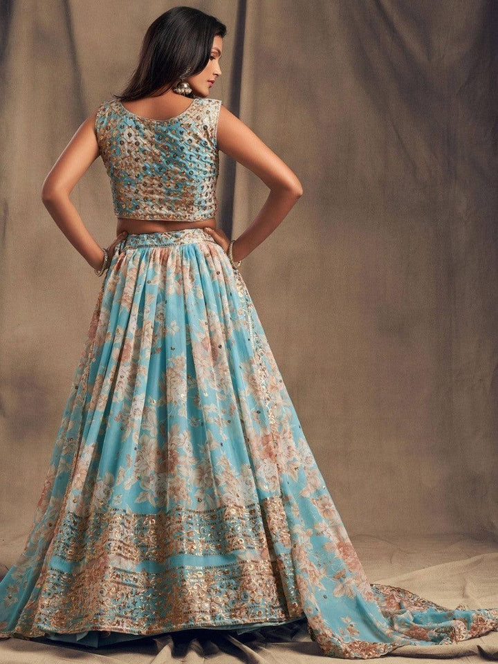 Organza sky blue lehenga with matching embroidered choli and dupatta.