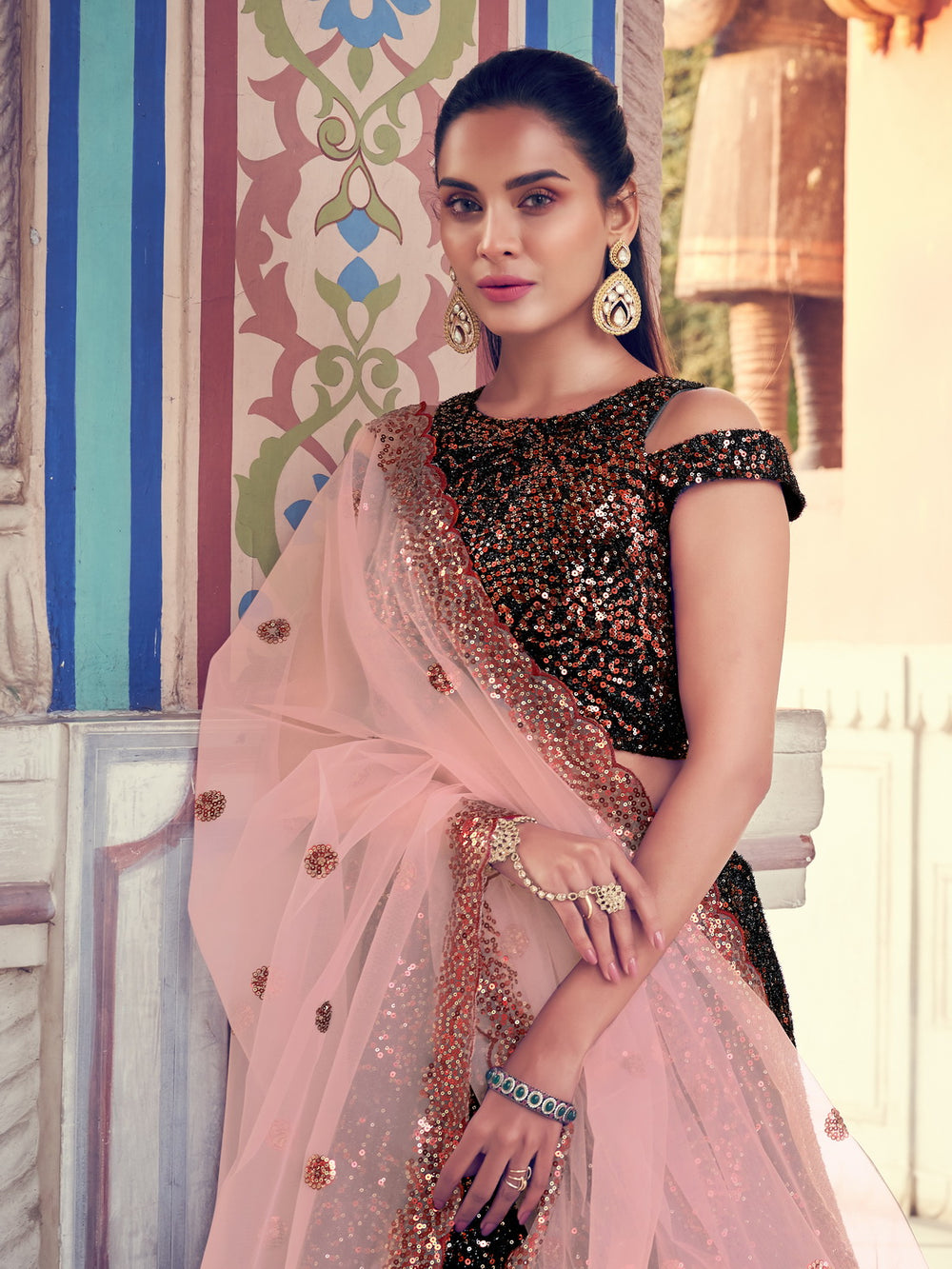 Buy black lehenga with intricate sparkling designs and peach dupatta