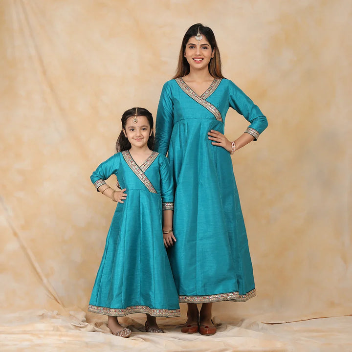 Exquisite Peacock Blue Ethnic Silk Gown Set for Mom and Daughter – Perfectly Coordinated Twin Outfits
