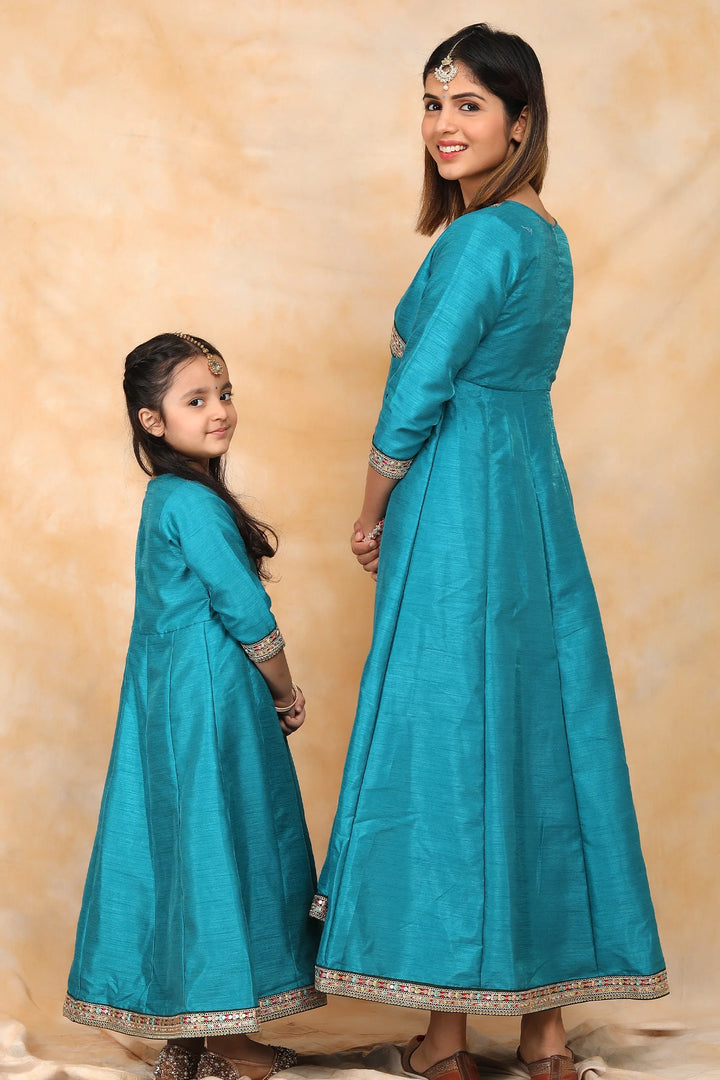 Exquisite Peacock Blue Ethnic Silk Gown Set for Mom and Daughter – Perfectly Coordinated Twin Outfits