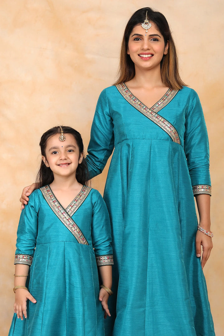 Exquisite Peacock Blue Ethnic Silk Gown Set for Mom and Daughter – Perfectly Coordinated Twin Outfits