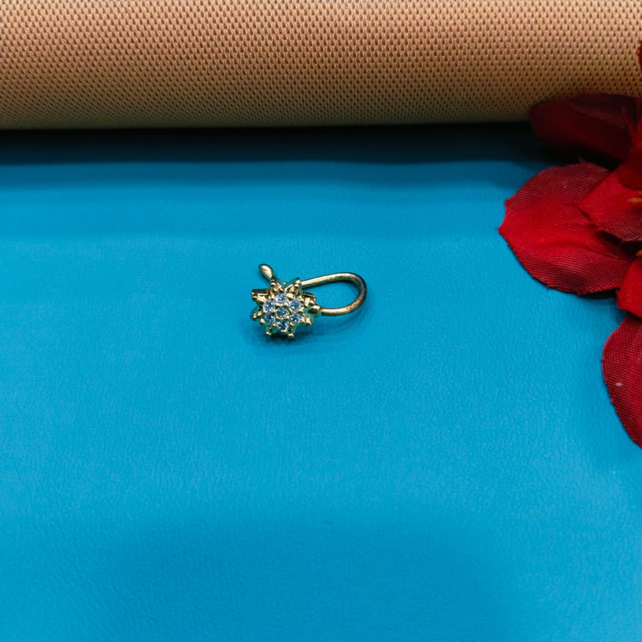 Stunning golden nose ring with artistic carvings, perfect for special events.