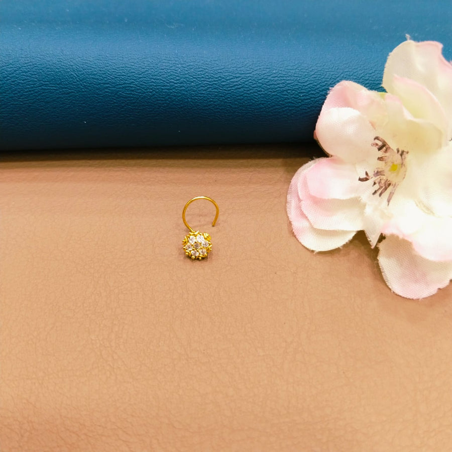 Gorgeous golden nose ring with delicate patterns, great for cultural attire.