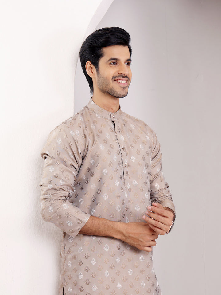 Stylish and breathable light brown kurta set with delicate handwoven motifs for a festive look.
