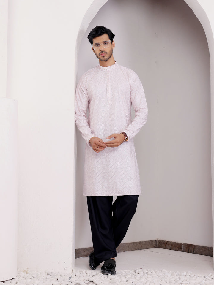 Light pink kurta set for men with handwoven motifs and fine Chikankari embroidery, perfect for cultural events.