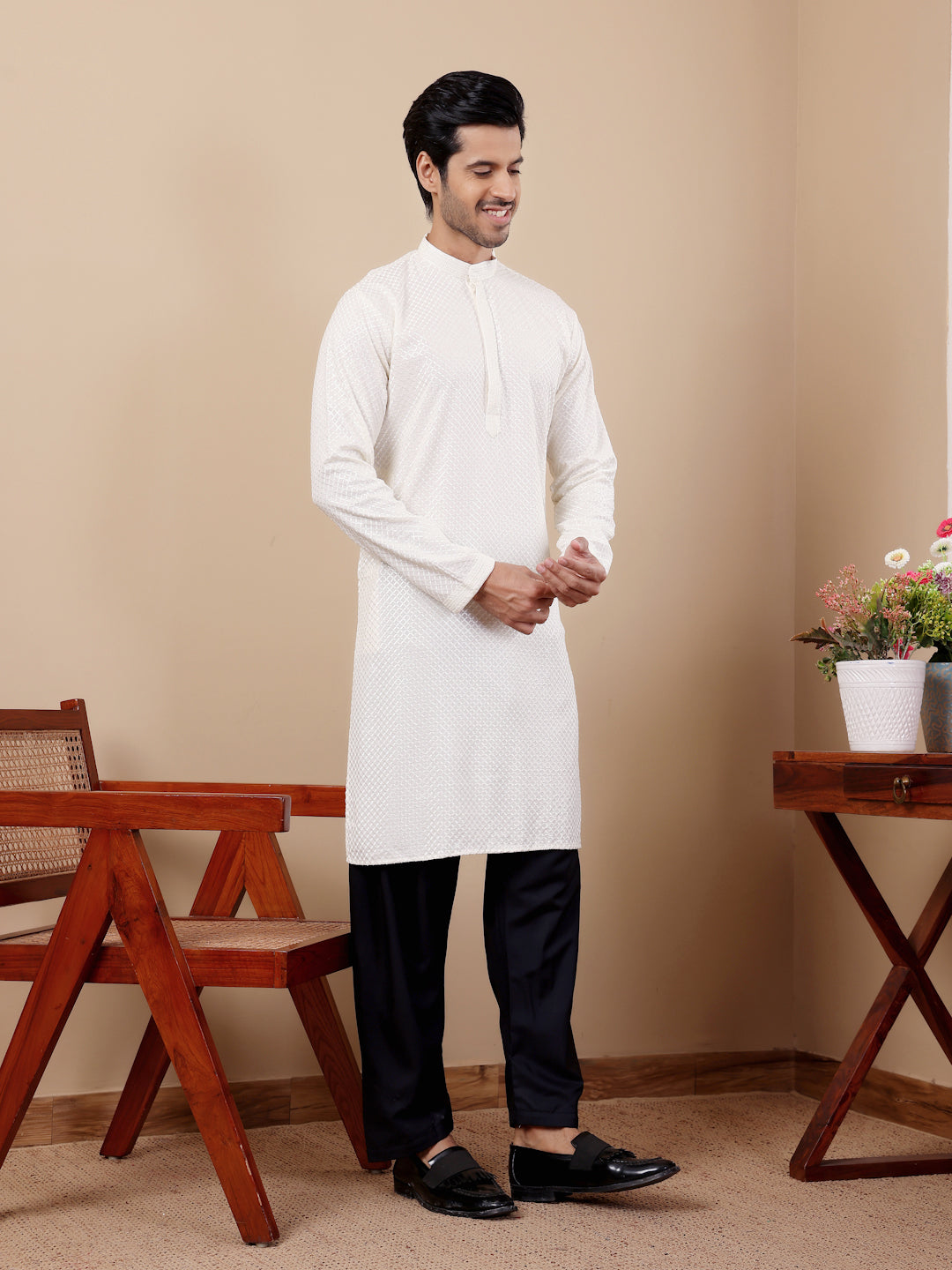 Men’s white kurta with detailed Chikankari embroidery and handwoven accents.