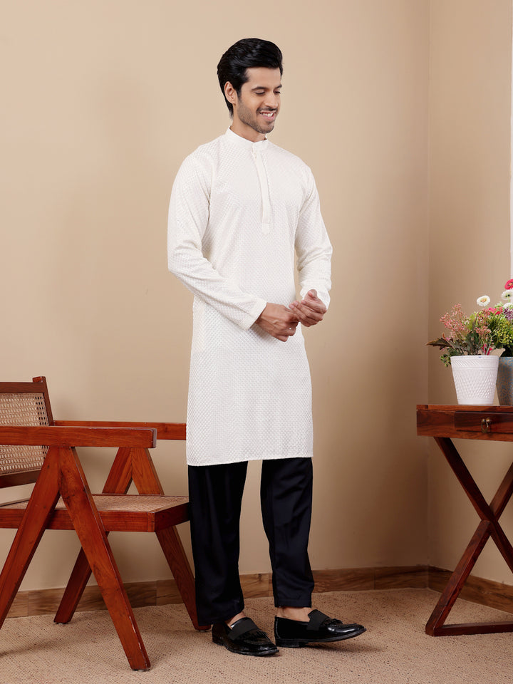 Men’s white kurta with detailed Chikankari embroidery and handwoven accents.