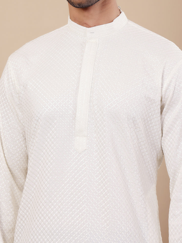 Men’s white kurta set made of Viscose fabric with delicate Chikankari embroidery and handwoven accents for an elegant appearance.