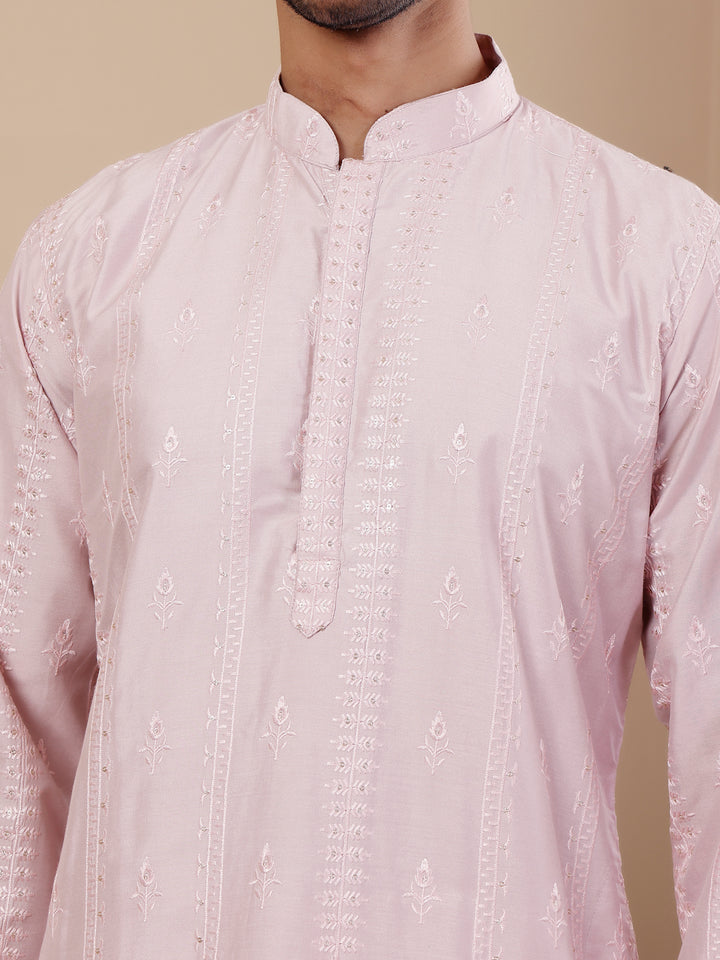 Handcrafted light pink kurta set for men featuring exquisite design and breathable fabric.