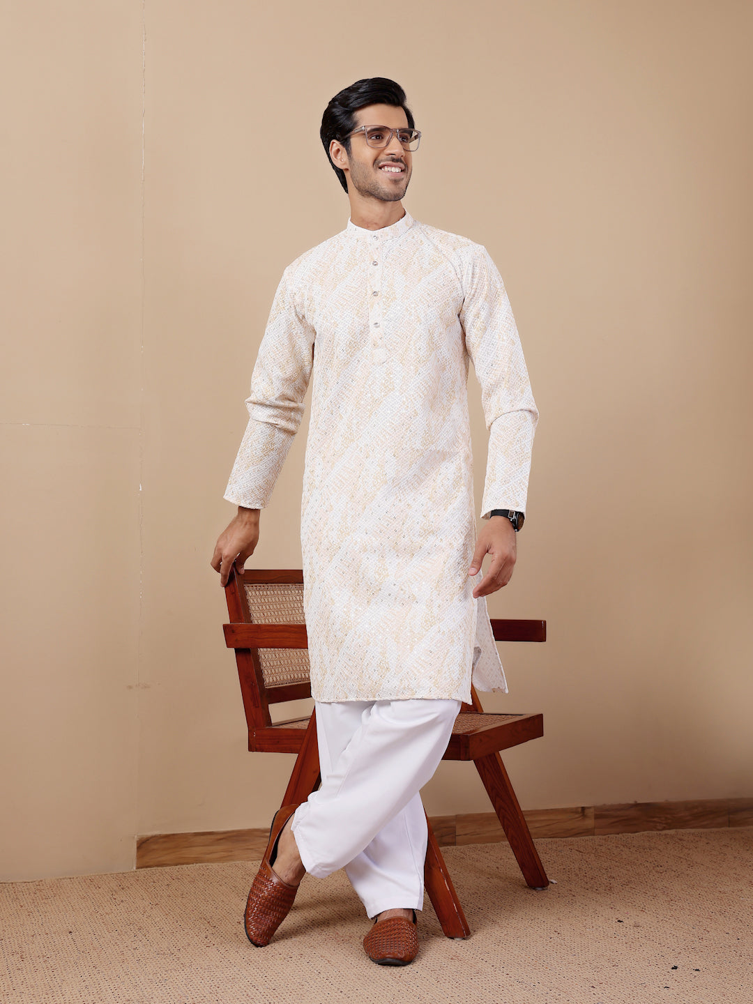 Festive yellow kurta pajama for men with detailed embroidery and soft earthy tones.