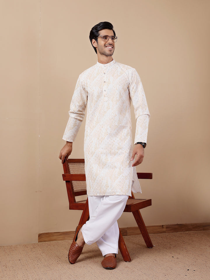 Festive yellow kurta pajama for men with detailed embroidery and soft earthy tones.