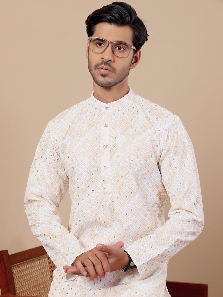 Designer yellow kurta pajama featuring stunning tie-dye work and chikankari motifs.