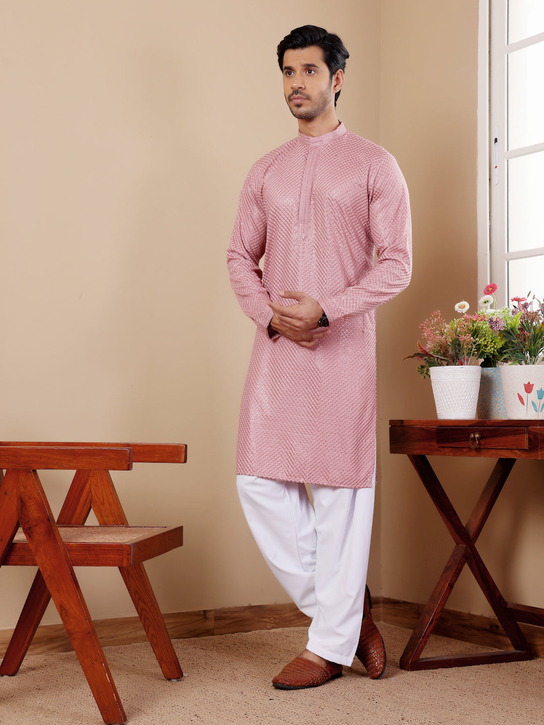 Elegant onion pink kurta set for men with delicate Chikankari embroidery and luxurious art silk bottoms.