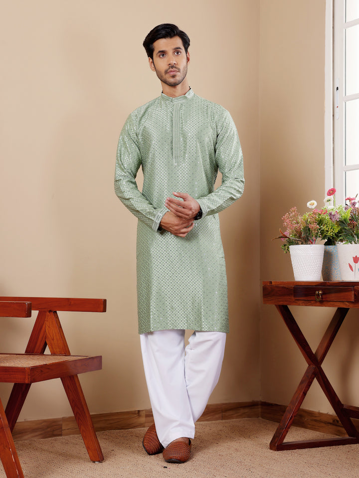 Pastel green kurta set for men with intricate Chikankari embroidery and art silk bottoms.