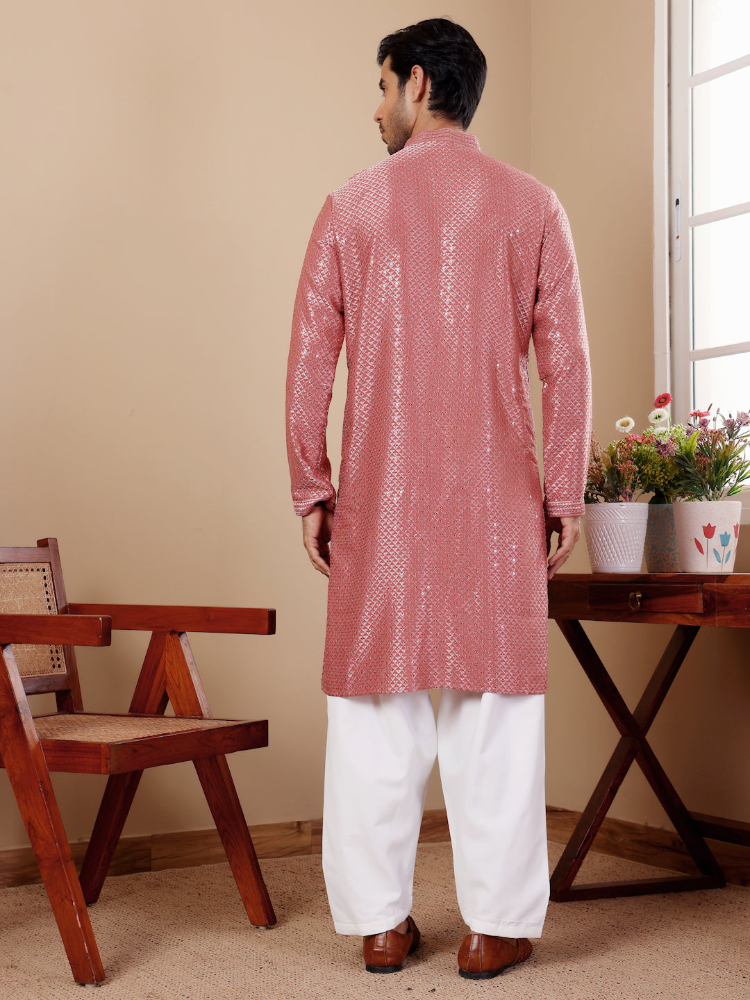 Stylish pastel red kurta featuring intricate Chikankari embroidery for festive occasions.