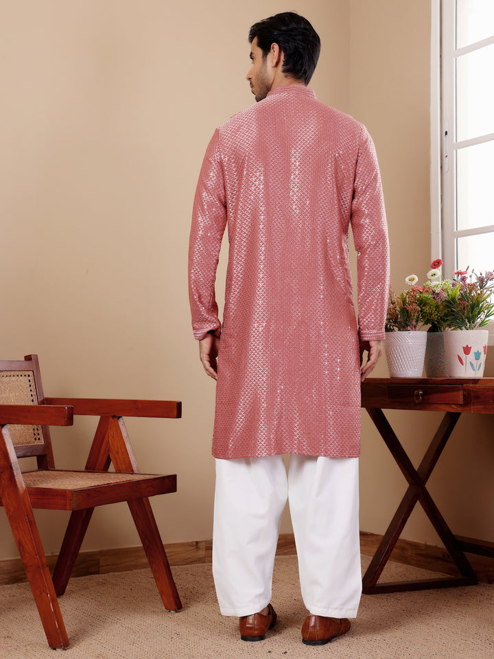 Stylish pastel red kurta featuring intricate Chikankari embroidery for festive occasions.
