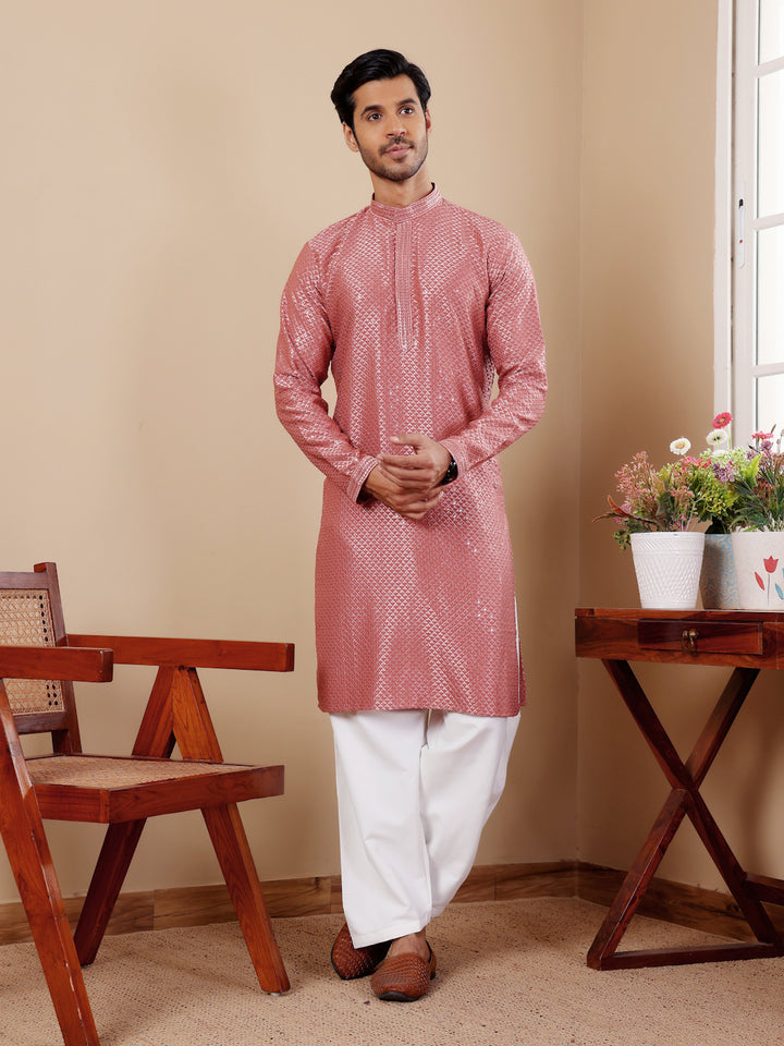 Pastel red kurta set for men with delicate Chikankari embroidery and art silk bottoms.