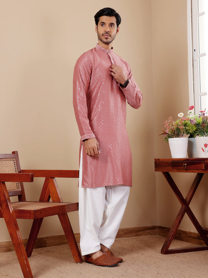 Elegant pastel red kurta set for men with Chikankari work, perfect for formal events.