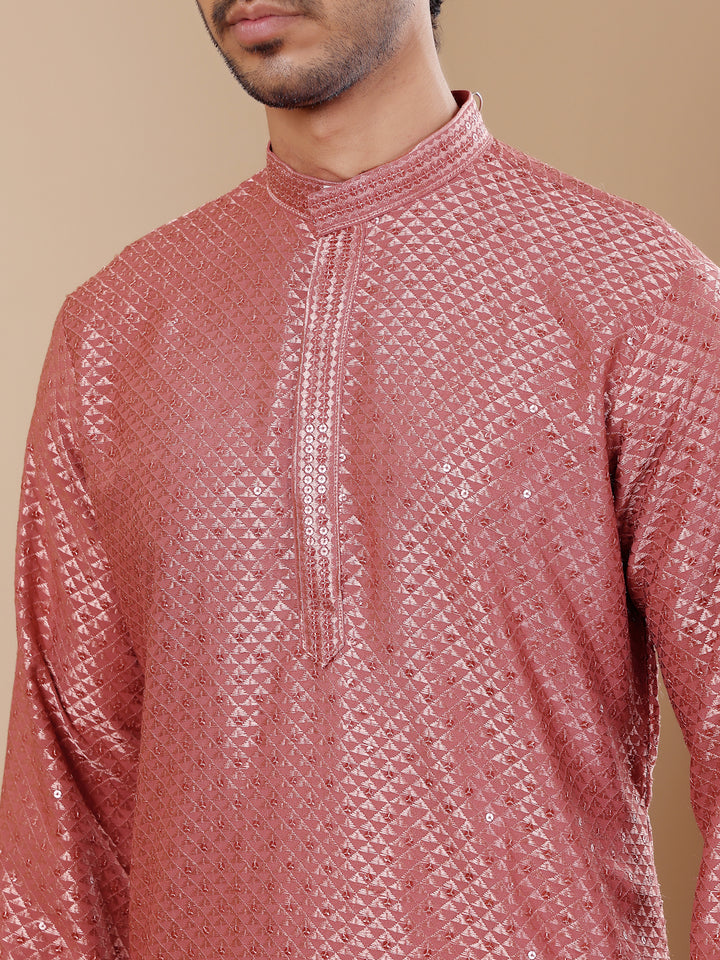 Elegant pastel red kurta with detailed Chikankari work and art silk bottoms for men.