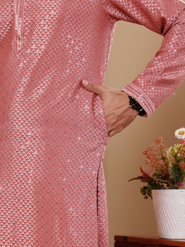 Pastel red kurta set for men featuring exquisite embroidery, perfect for cultural celebrations.
