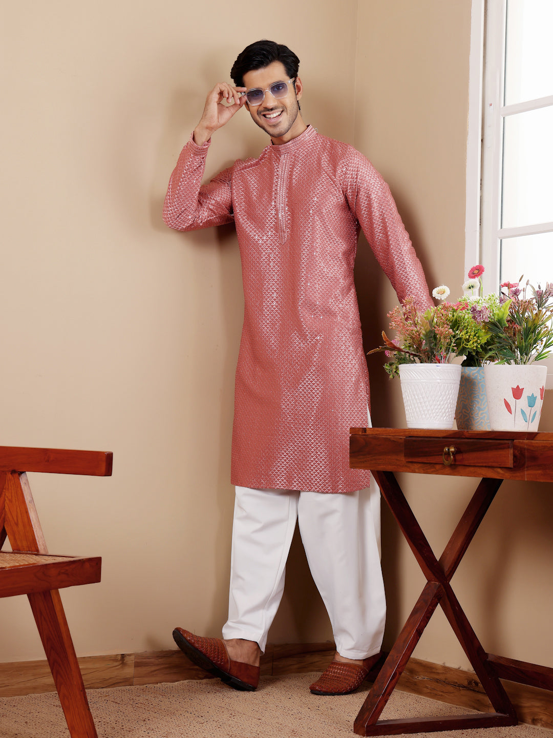 Traditional pastel red kurta for men with delicate embroidery and art silk bottoms.