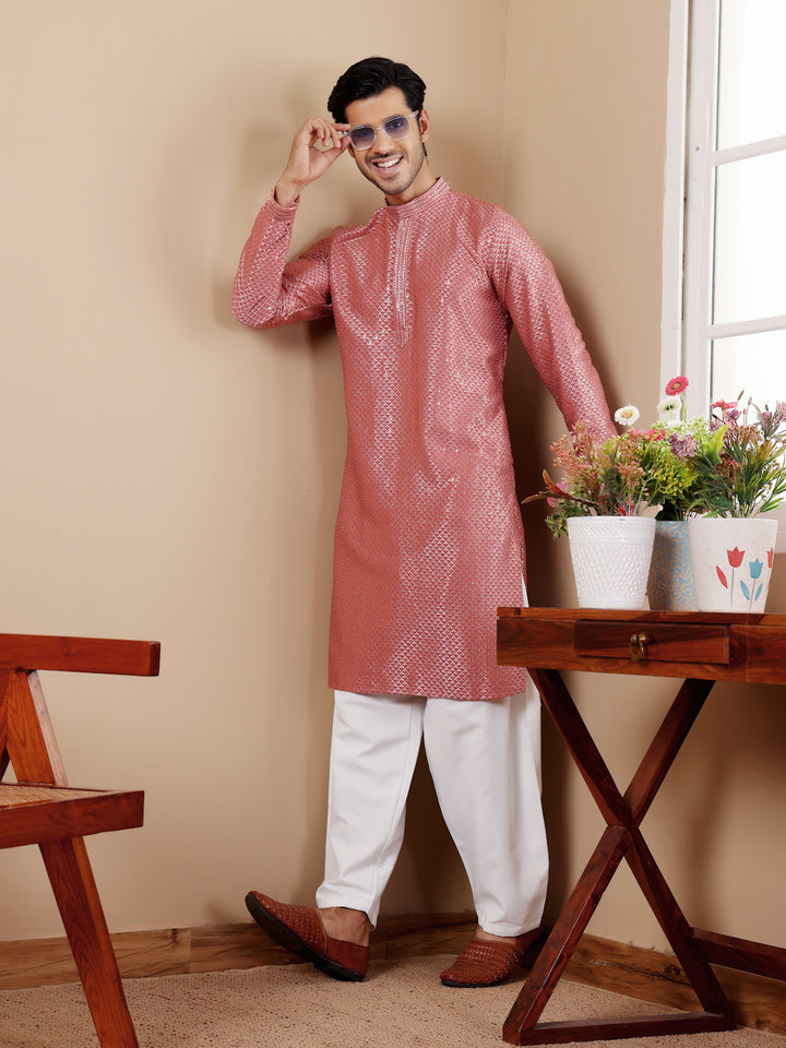 Traditional pastel red kurta for men with delicate embroidery and art silk bottoms.
