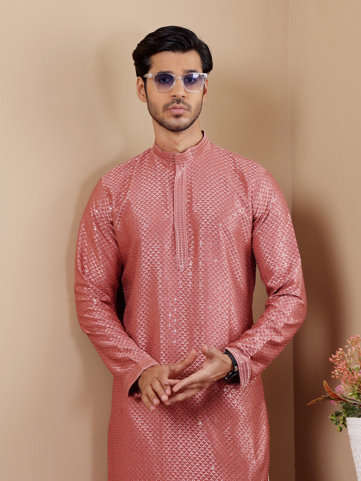 Comfortable pastel red kurta with Chikankari work, ideal for family gatherings.