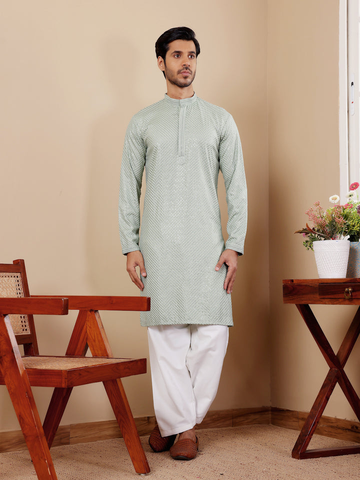 Sophisticated light pastel green Viscose kurta set with intricate Chikankari work and art silk bottoms.