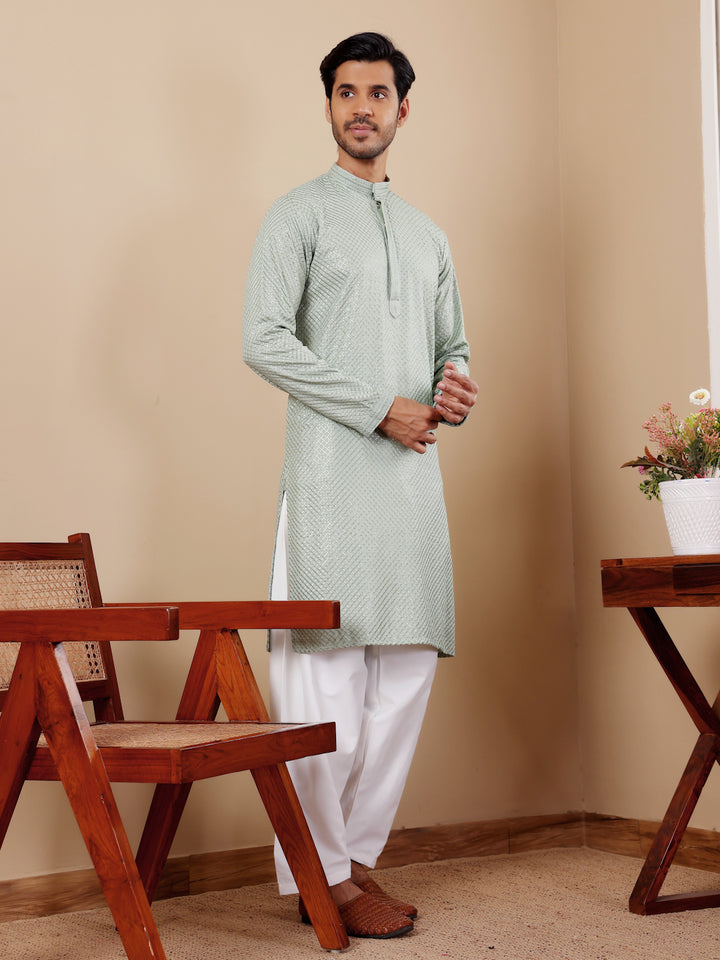 Elegant light pastel green kurta set with delicate Chikankari detailing and art silk bottoms.