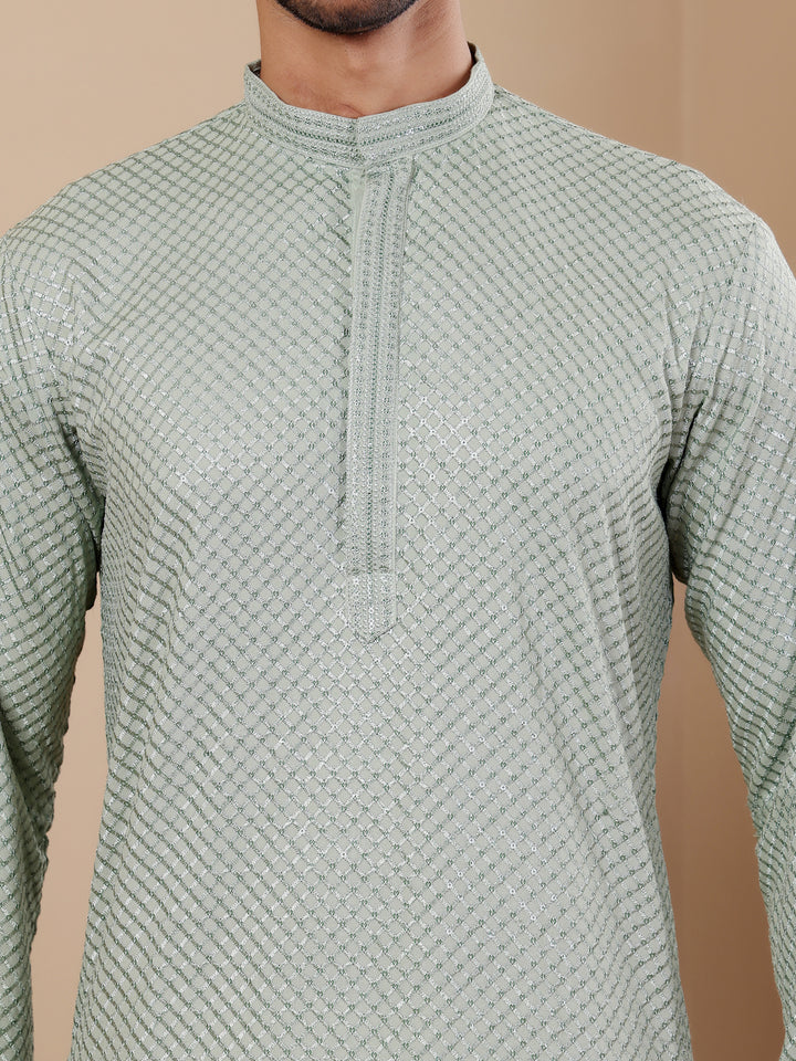 Timeless light pastel green kurta for men with intricate Chikankari embroidery and art silk bottoms.