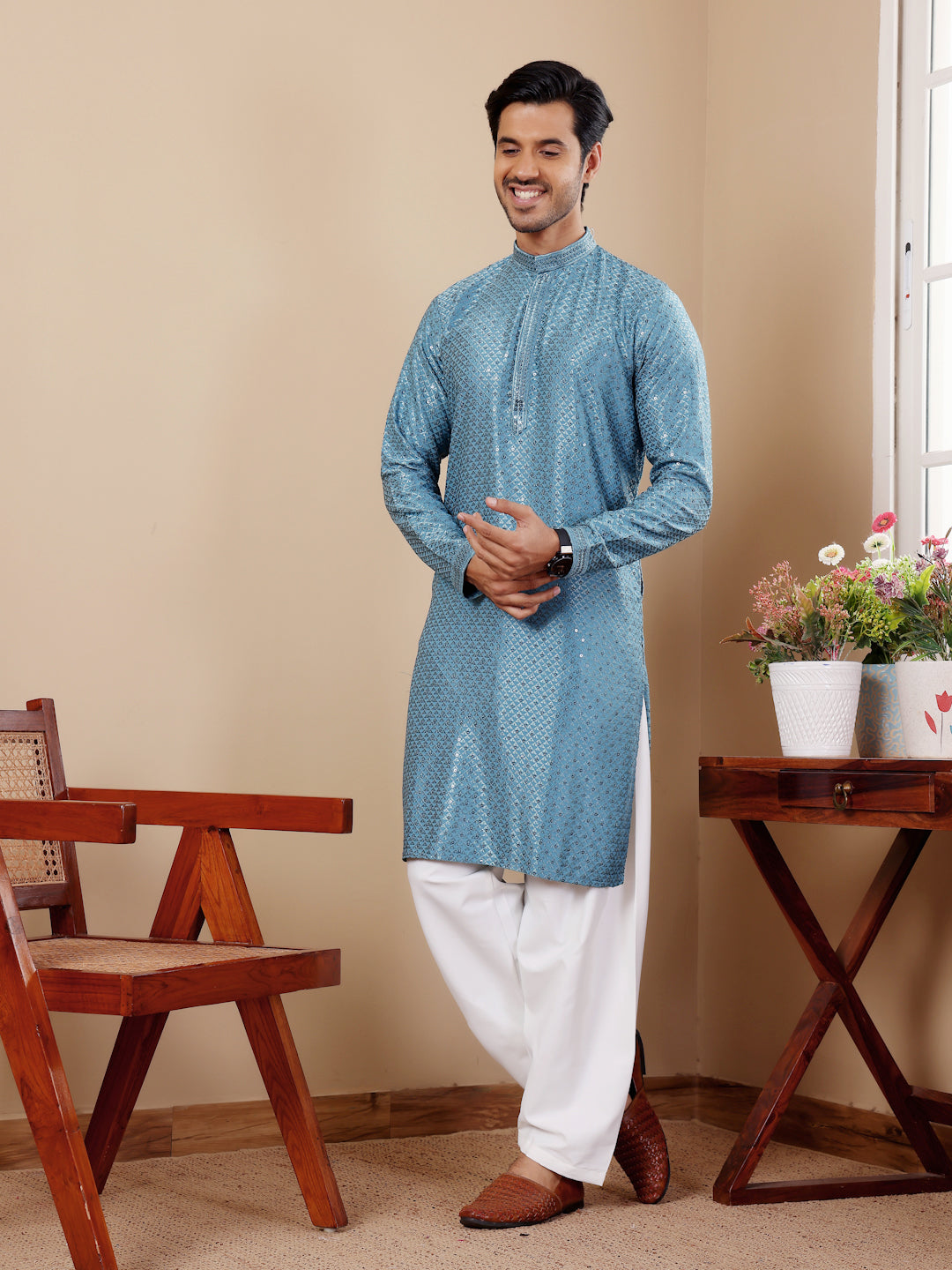 Traditional cyan blue kurta with Chikankari detailing, perfect for cultural events.