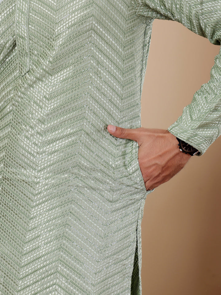 Festive pastel green kurta set with Chikankari embroidery and handwoven accents, designed for men.