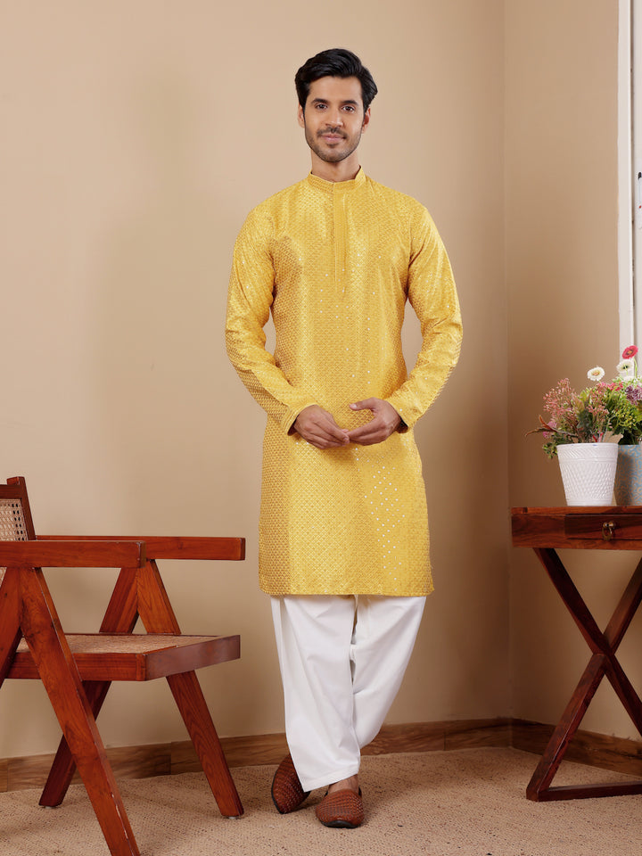 Yellow kurta set for men with Chikankari embroidery and art silk bottoms for a festive look.