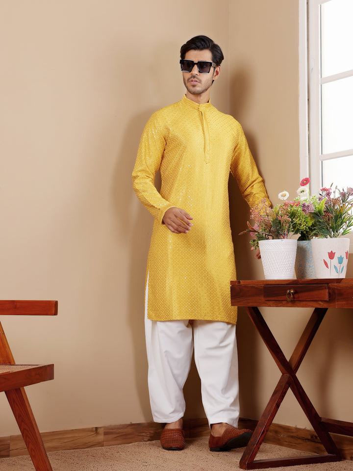 Yellow kurta with delicate Chikankari detailing and art silk bottoms for a sophisticated look.