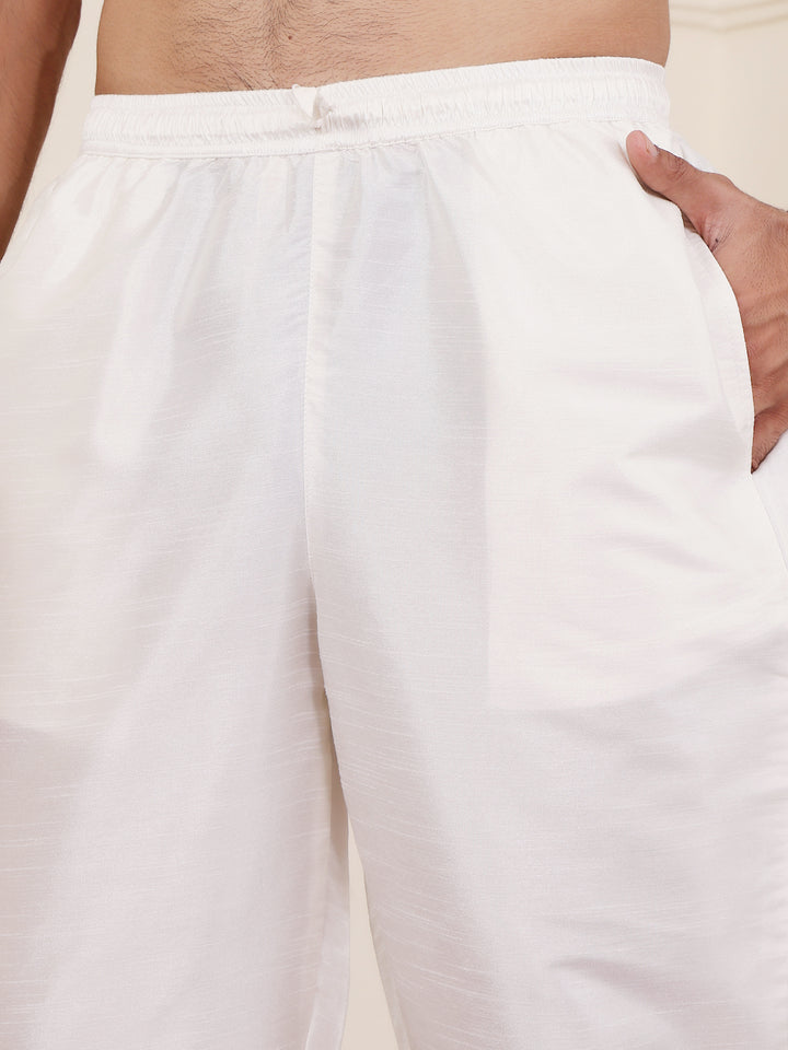 Elegant cream-colored art silk bottom wear for men, featuring a smooth texture and perfect tailoring for festive and formal occasions.