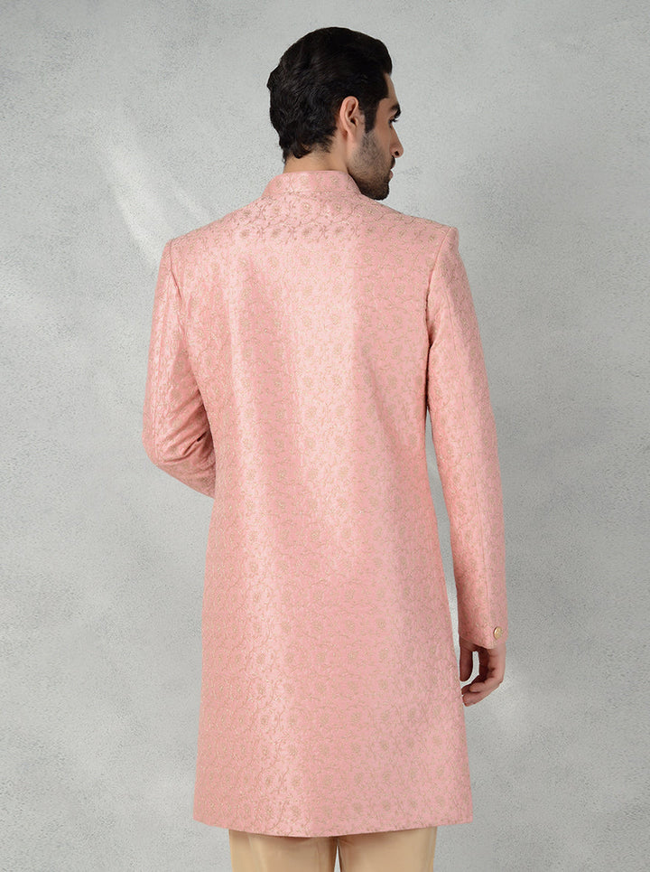 Stylish pink Indo-Western kurta for men, perfect for grooms, featuring intricate gold embroidery.