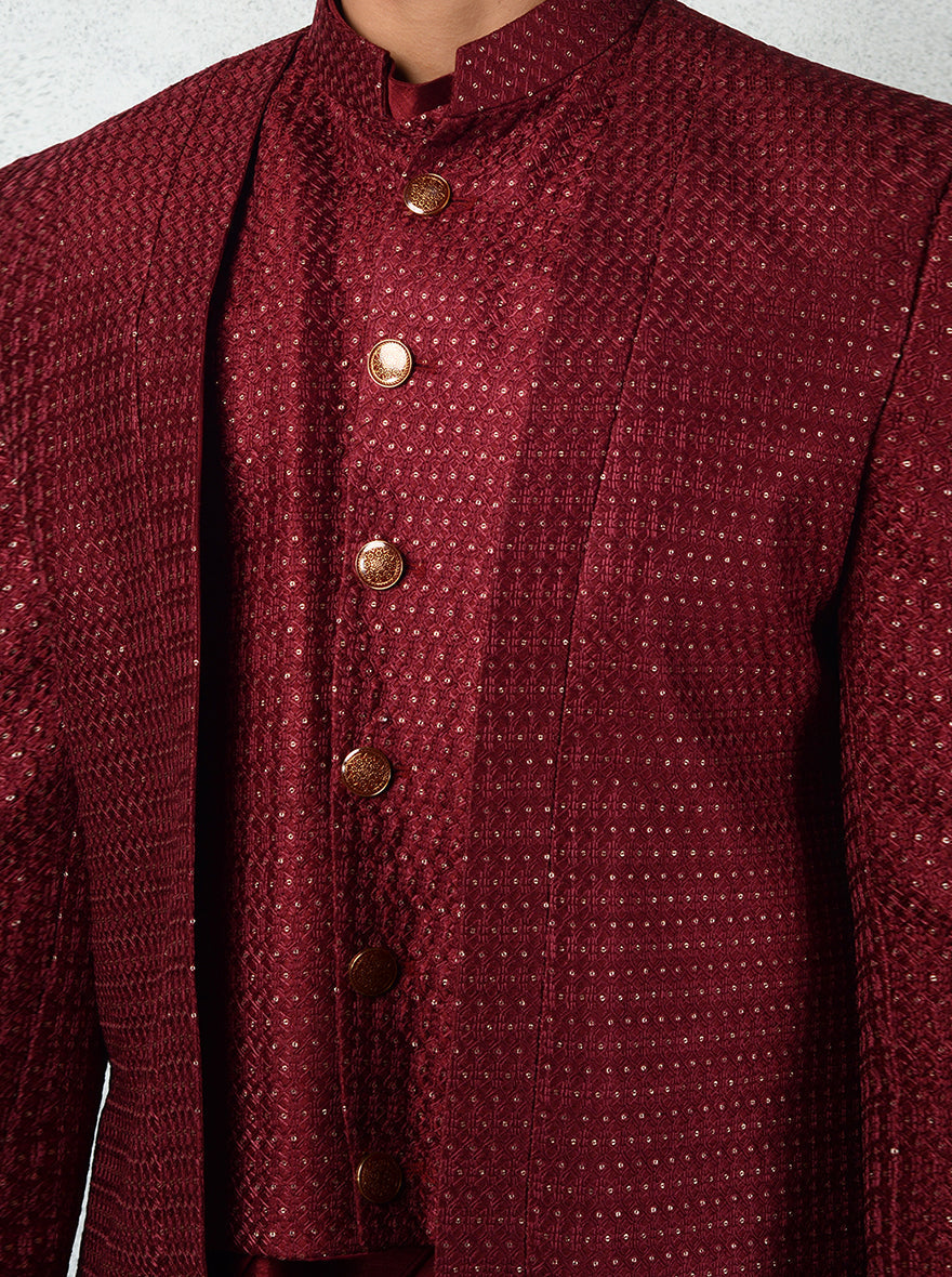Men’s maroon Indo-Western with a silk kurta, gold buttons, and slim trousers.